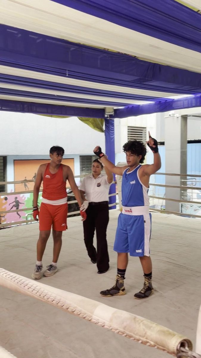 The referee raises Utkarsh's hand after the State final